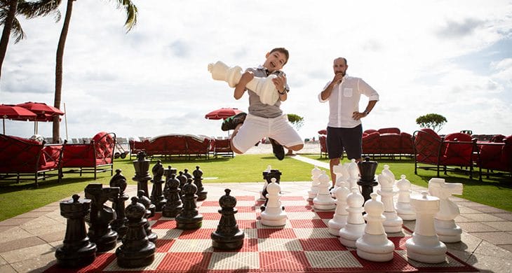 Boy jumping with giant chess piece in Miami, Florida