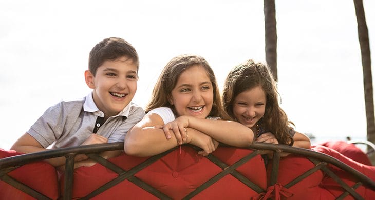 Kids on a red couch in Miami, Florida