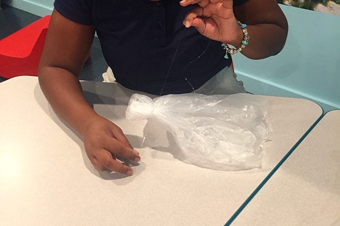 Gather the plastic bag at the center