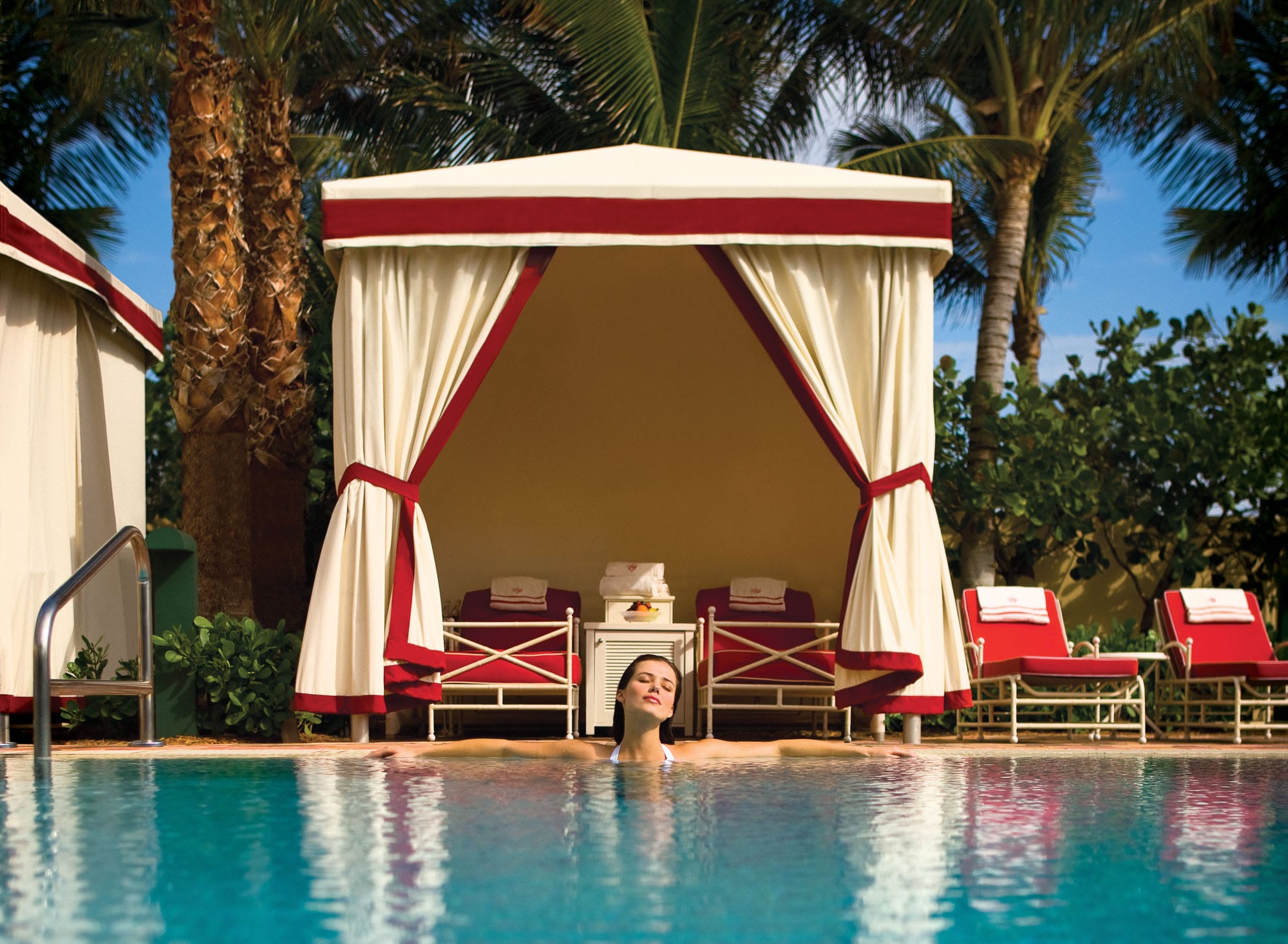 Woman in Acqualina's Pool In Front of a Cabana