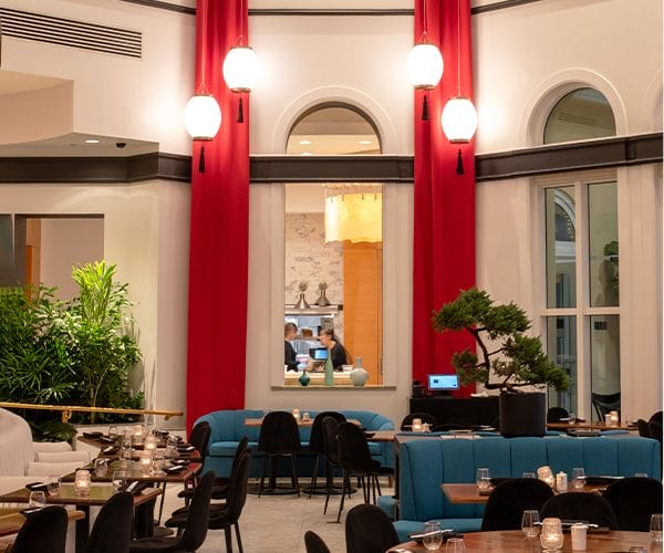 elegant restaurant dining room with red drapes and modern seating