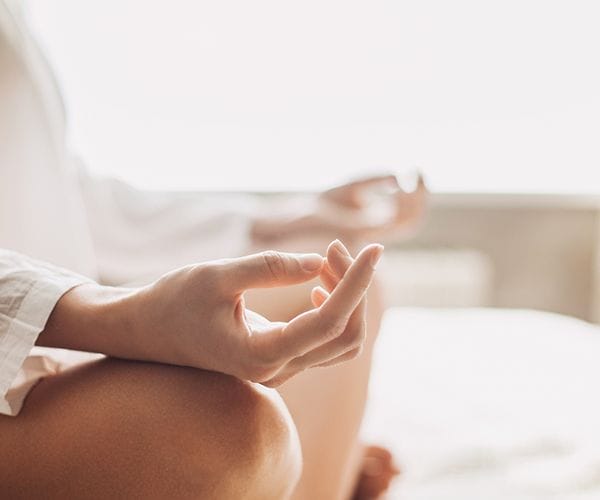 person meditating with hands in mindfulness pose
